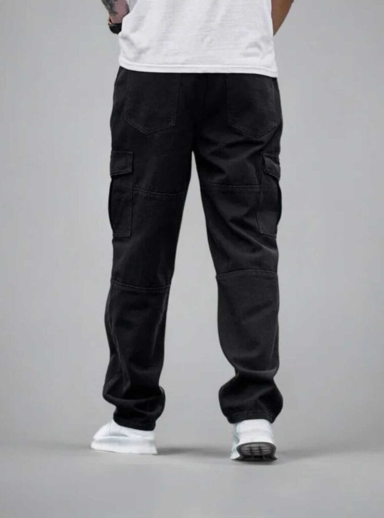 Back view of a man wearing N Club black baggy cargo jeans, showcasing the relaxed fit, back pockets, and panelled knee details