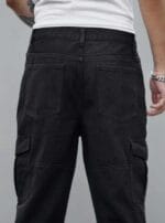 Back view of a man wearing N Club black baggy cargo jeans, showcasing the relaxed fit, back pockets